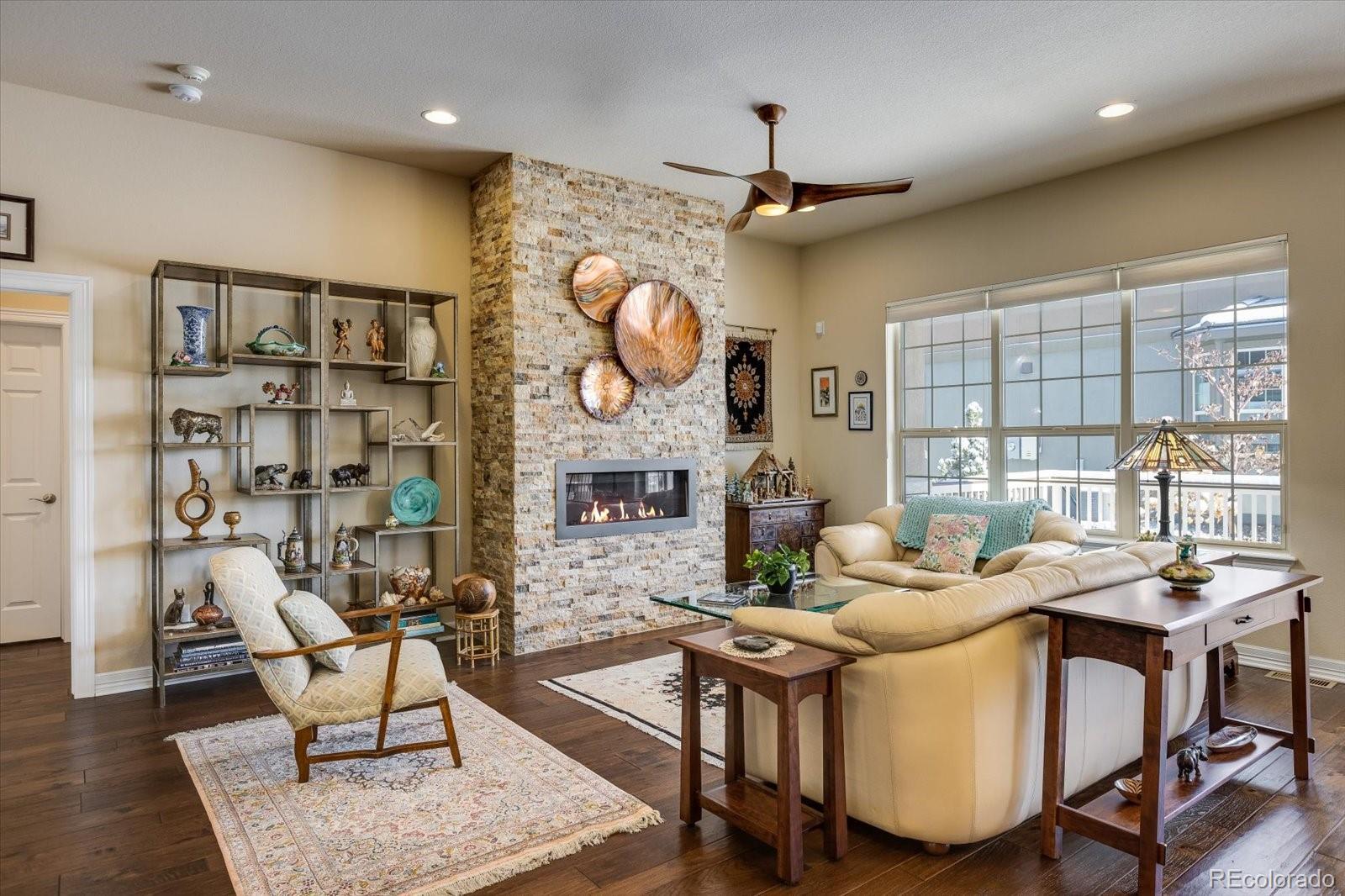 15712 Rito Alto Run Broomfield, CO 80023 - Photo 4 of 26 a living room with fireplace furniture and a large window