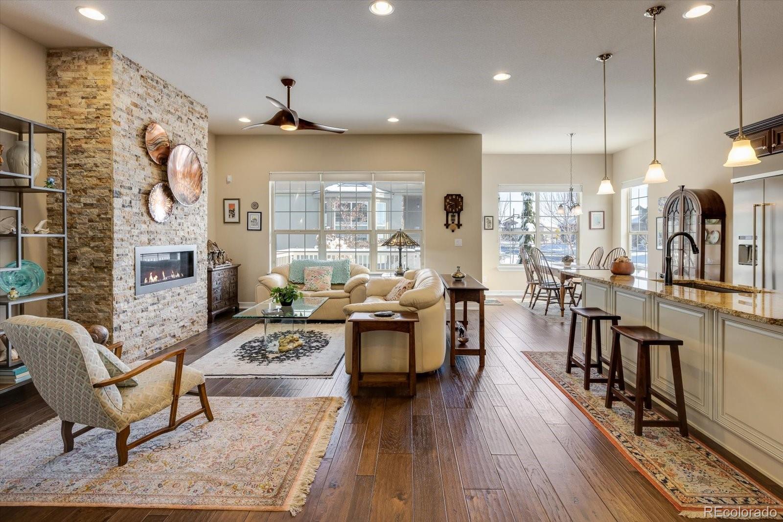 15712 Rito Alto Run Broomfield, CO 80023 - Photo 5 of 26 a living room with fireplace furniture and a wooden floor