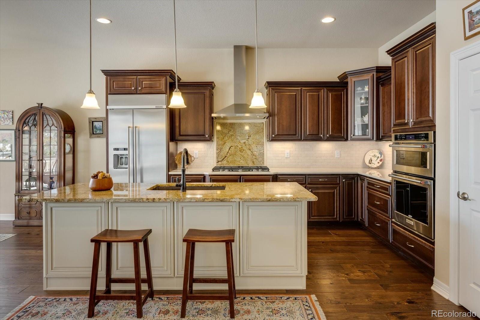 15712 Rito Alto Run Broomfield, CO 80023 - Photo 7 of 26 a kitchen with stainless steel appliances granite countertop a stove a sink and a refrigerator