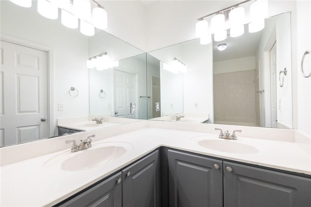 3334 Peachtree Road Northeast, Unit 905 Atlanta, GA 30326 - Photo 13 of 29 a bathroom with a sink and a mirror
