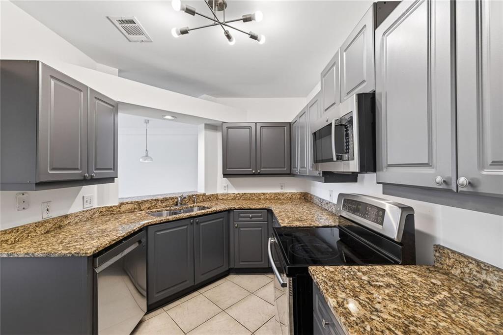 3334 Peachtree Road Northeast, Unit 905 Atlanta, GA 30326 - Photo 9 of 29 a kitchen with a sink and a stove top oven