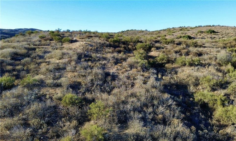 27920 Vista Suelto Road Moreno Valley, CA 92555 - Photo 14 of 16 a view of a building with mountains