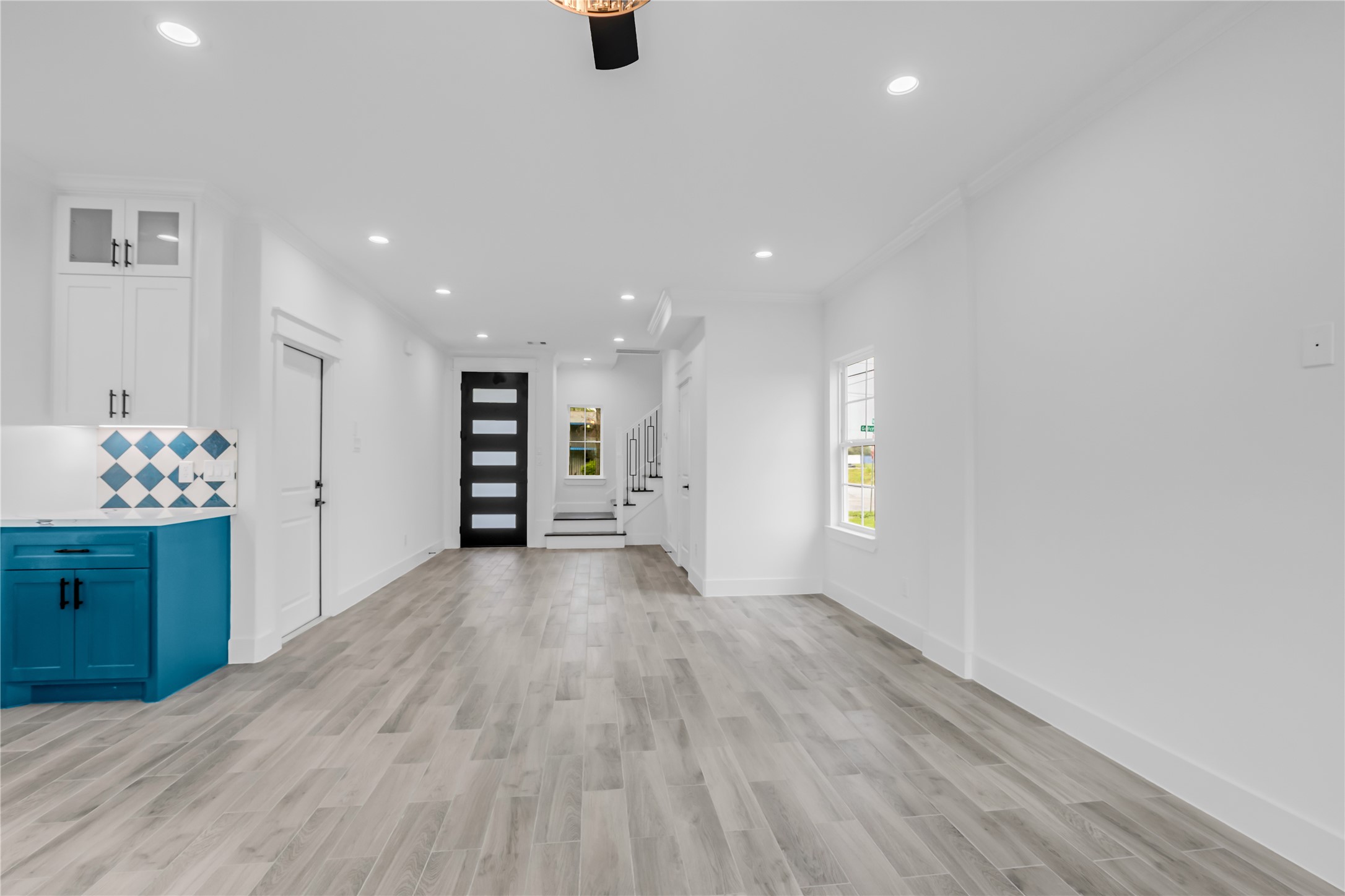 3168 Golfcrest Houston, TX 77087 - Photo 17 of 36 This stylish living room boasts sleek wood flooring, vibrant cabinetry, and a modern open layout, perfect for contemporary living.