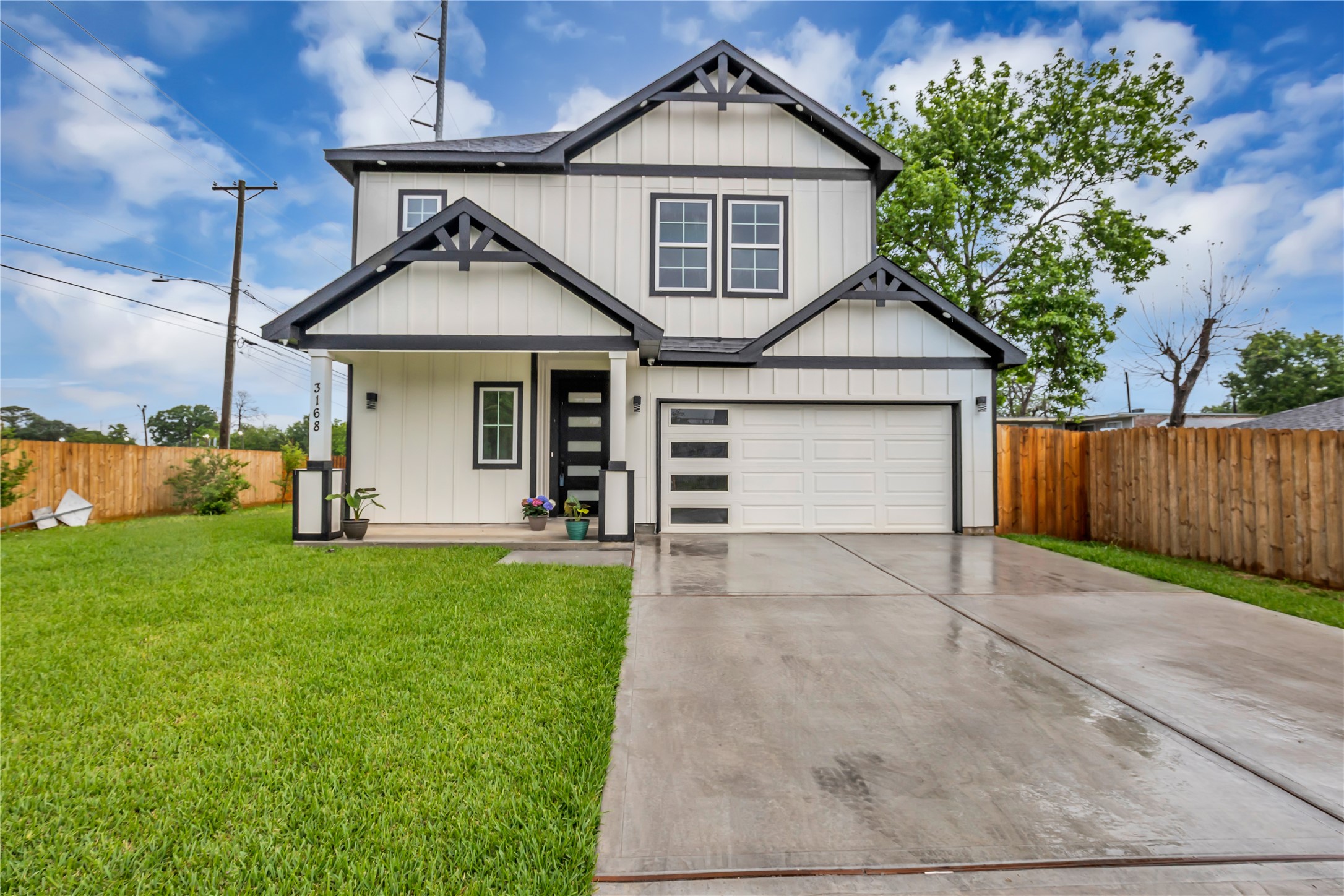 3168 Golfcrest Houston, TX 77087 - Photo 2 of 36 Discover modern elegance in this inviting two-story home, featuring a sleek facade, manicured lawn, and a spacious driveway leading to a charming covered porch—perfect for your dream lifestyle.