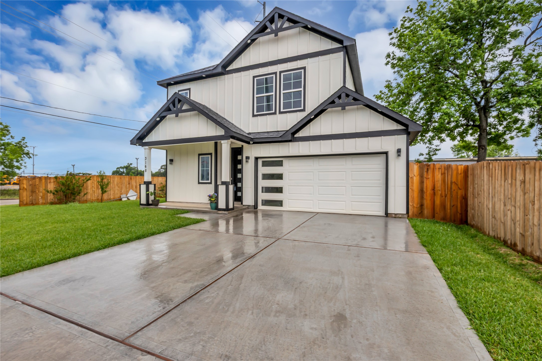 3168 Golfcrest Houston, TX 77087 - Photo 3 of 36 This modern home features a sleek facade with clean lines and a spacious driveway, complemented by a charming front porch and lush green lawn.