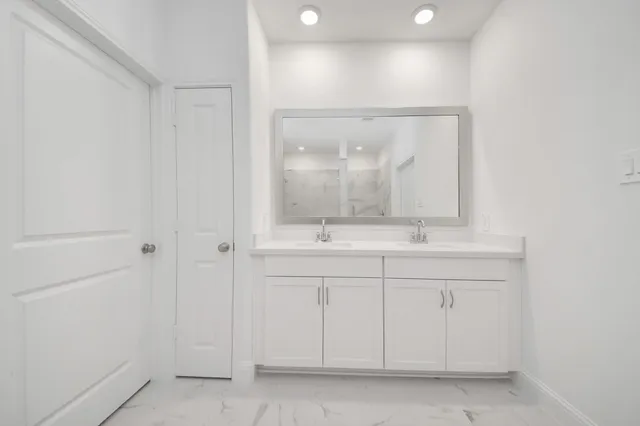 a bathroom with a sink a vanity and a mirror