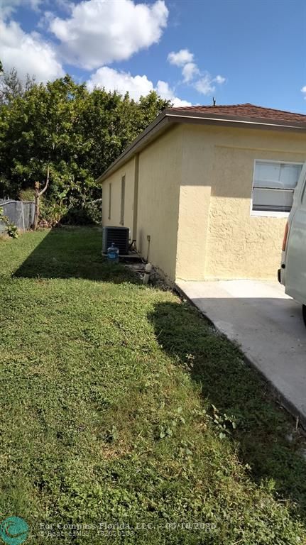 312 Carissa Drive Pahokee, FL 33476 - Photo 14 of 14 a view of a house with a yard