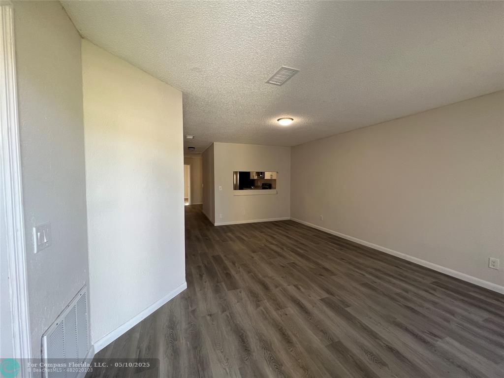 312 Carissa Drive Pahokee, FL 33476 - Photo 3 of 14 a view of empty room with wooden floor