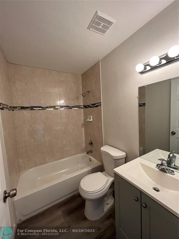 312 Carissa Drive Pahokee, FL 33476 - Photo 7 of 14 a bathroom with a toilet a sink and bathtub