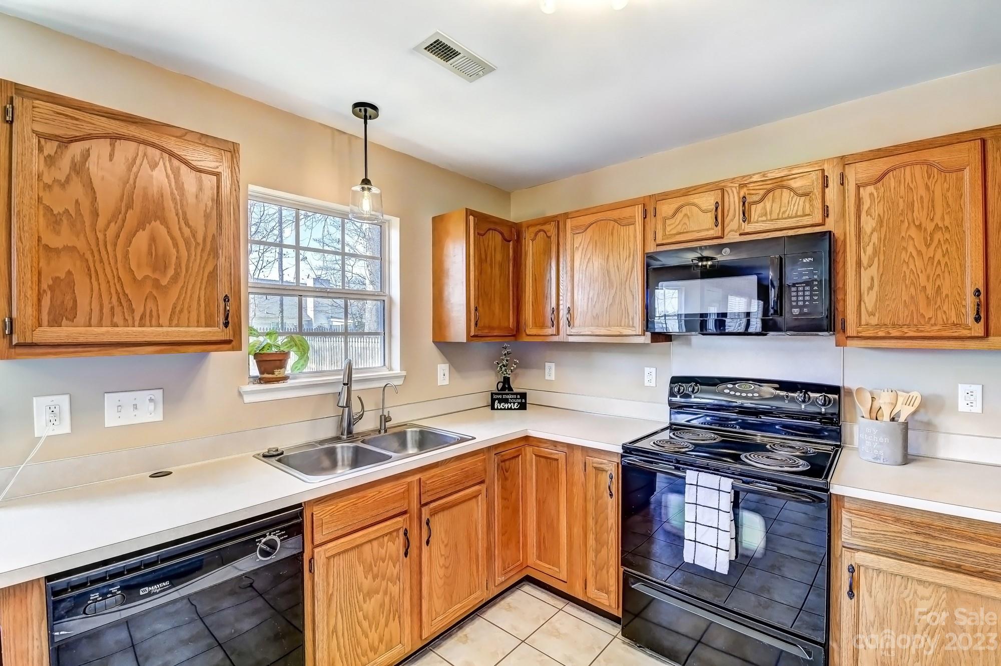 1663 Heather Glen Road Kannapolis, NC 28081 - Photo 11 of 40 a kitchen with stainless steel appliances granite countertop a sink stove cabinets and wooden floor