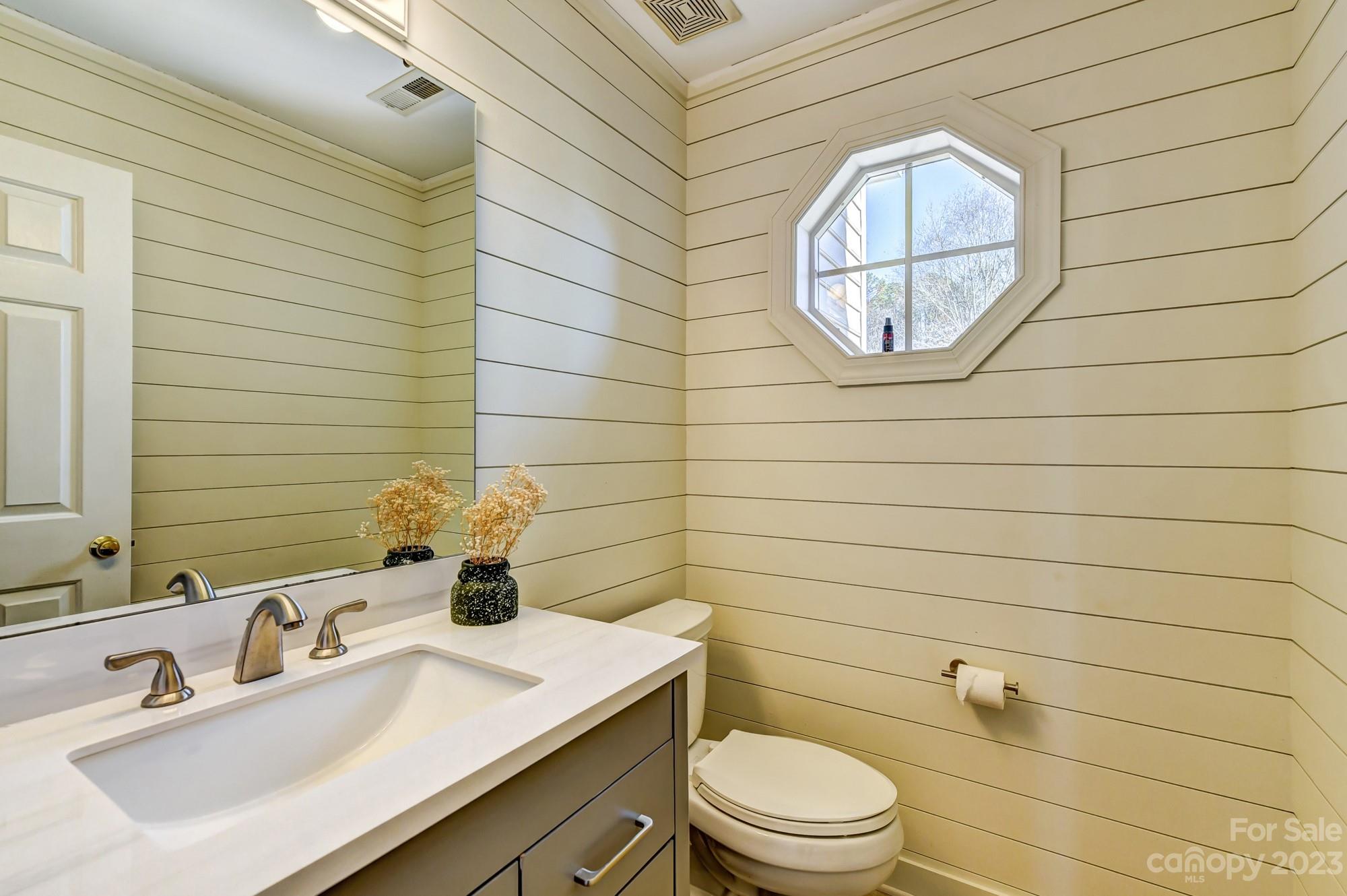 1663 Heather Glen Road Kannapolis, NC 28081 - Photo 16 of 40 a bathroom with a sink a mirror and a toilet