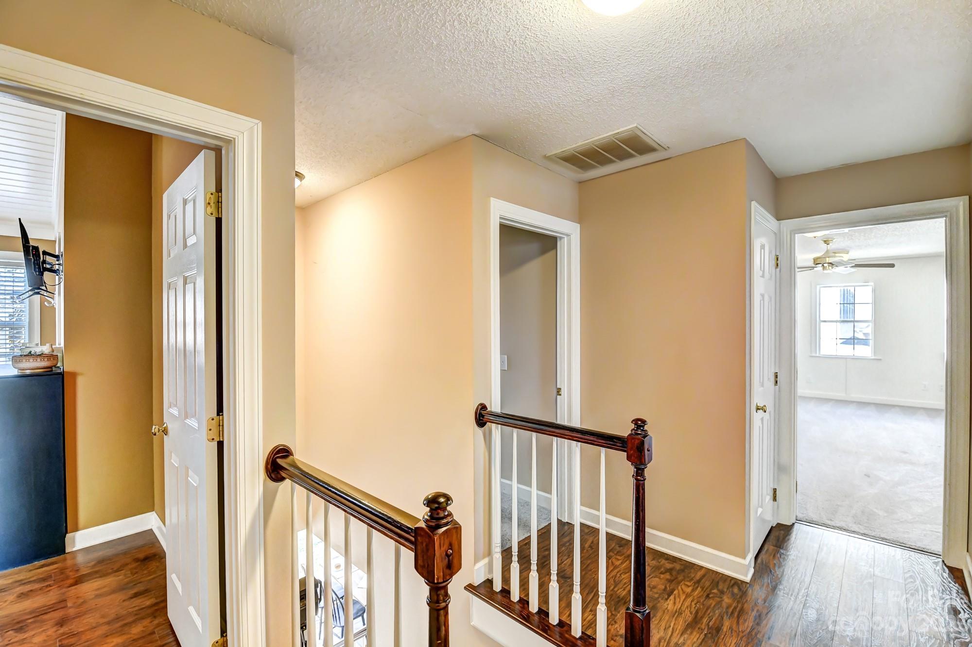 1663 Heather Glen Road Kannapolis, NC 28081 - Photo 18 of 40 a view of a hallway with wooden floor and staircase