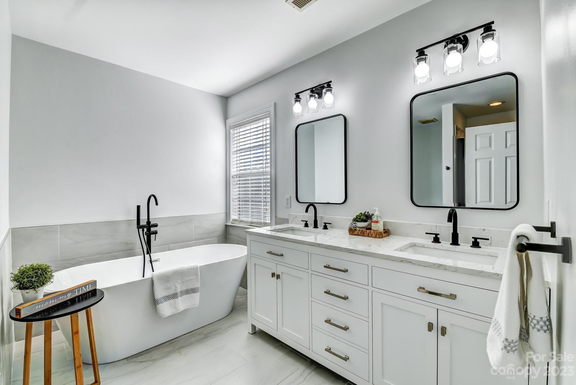 1663 Heather Glen Road Kannapolis, NC 28081 - Photo 22 of 40 a bathroom with a double vanity sink and a mirror