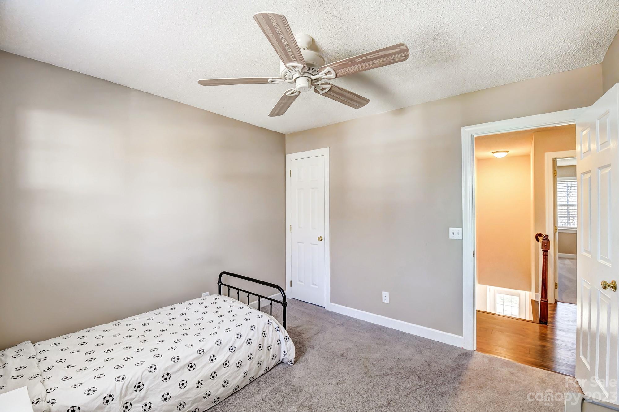 1663 Heather Glen Road Kannapolis, NC 28081 - Photo 25 of 40 a bedroom with a bed and a ceiling fan