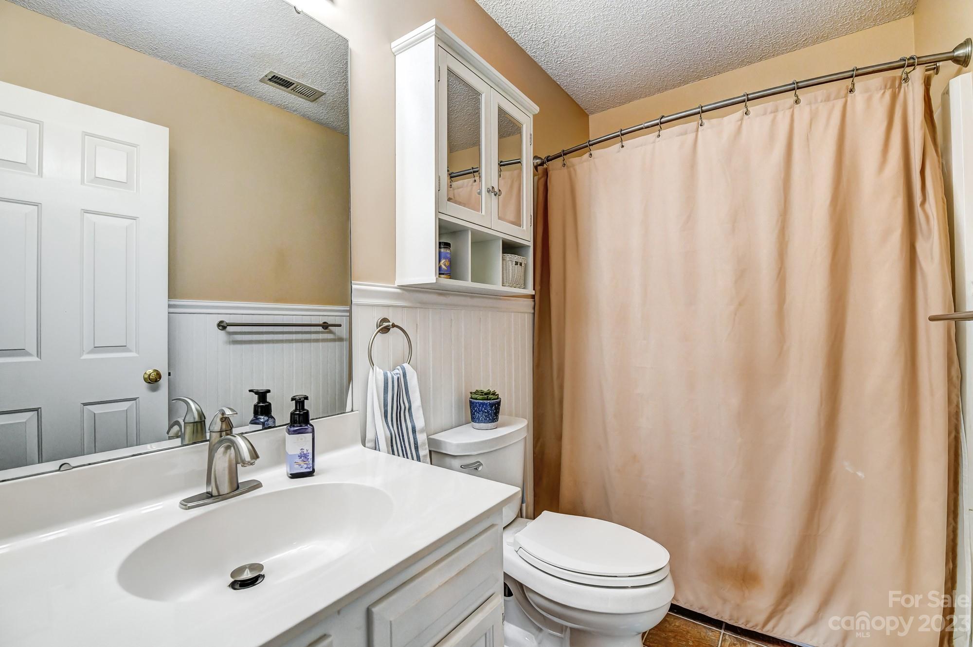1663 Heather Glen Road Kannapolis, NC 28081 - Photo 27 of 40 a bathroom with a sink a mirror and a toilet