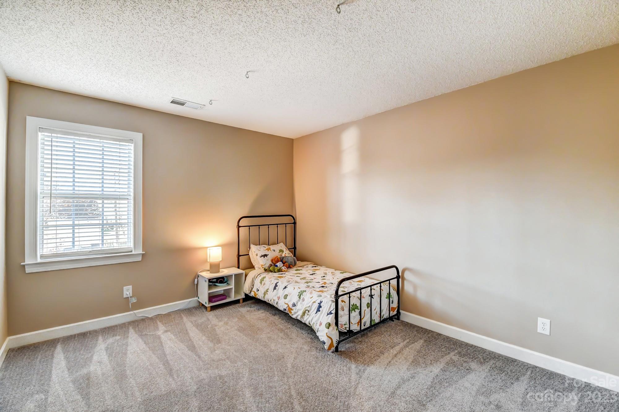 1663 Heather Glen Road Kannapolis, NC 28081 - Photo 28 of 40 a bedroom with a bed and a window