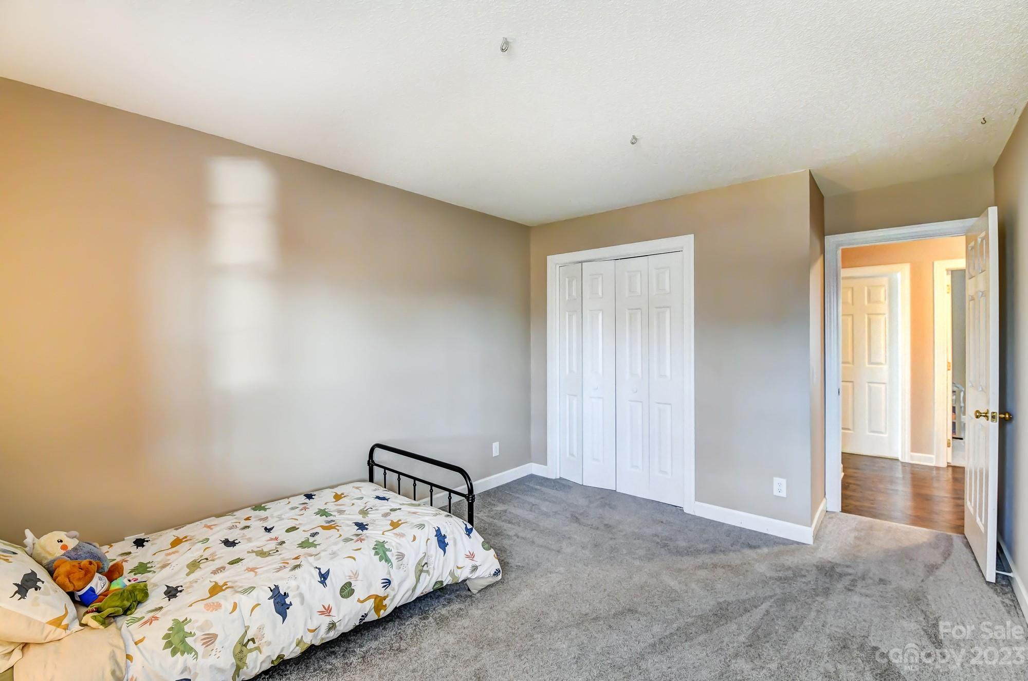 1663 Heather Glen Road Kannapolis, NC 28081 - Photo 29 of 40 a bedroom with a bed and hallway