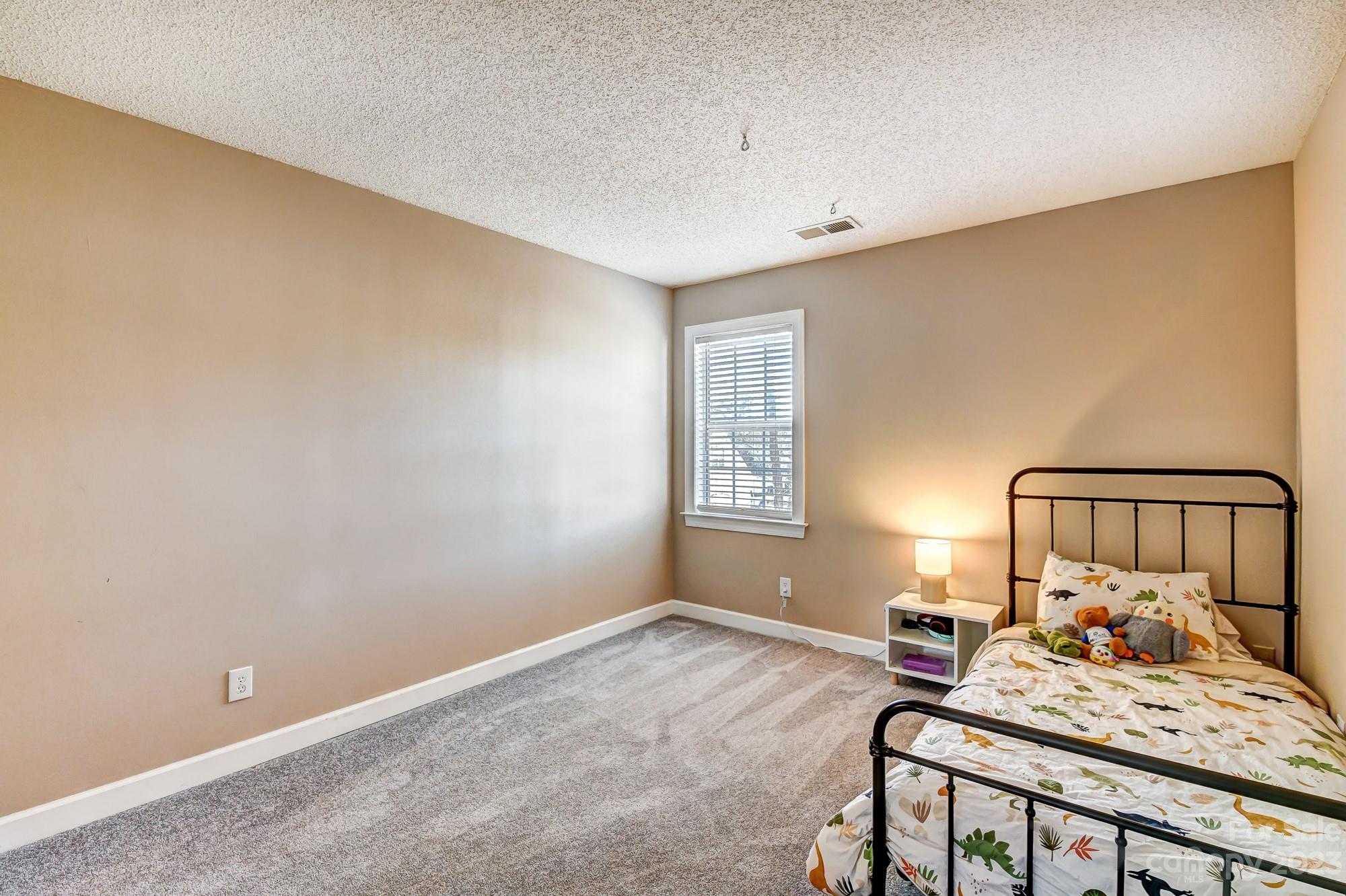 1663 Heather Glen Road Kannapolis, NC 28081 - Photo 30 of 40 a bedroom with a bed and a window
