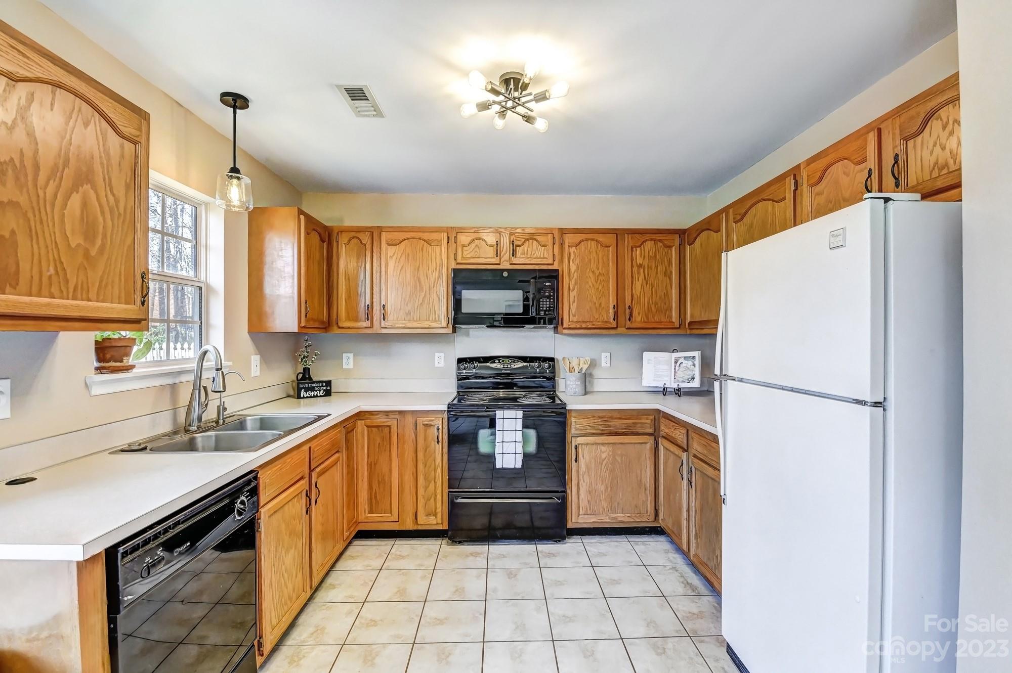 1663 Heather Glen Road Kannapolis, NC 28081 - Photo 10 of 40 a kitchen with a refrigerator a sink and a stove