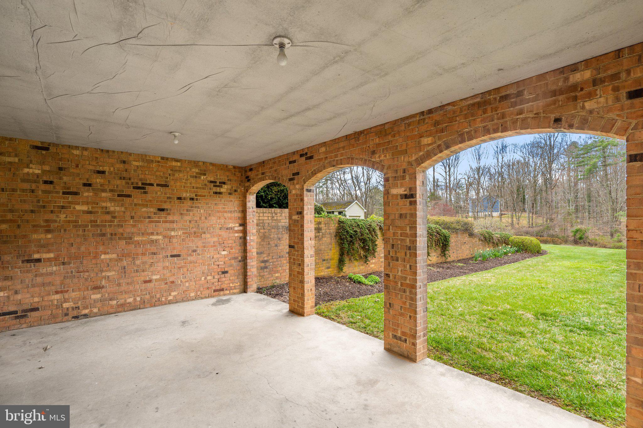 10328 Walker Road Culpeper, VA 22701 - Photo 68 of 79 Covered patio protected by retaining wall