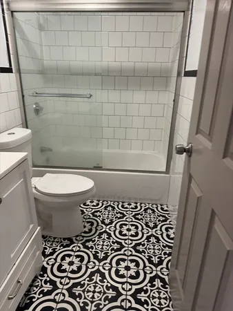 a bathroom with a toilet and a shower