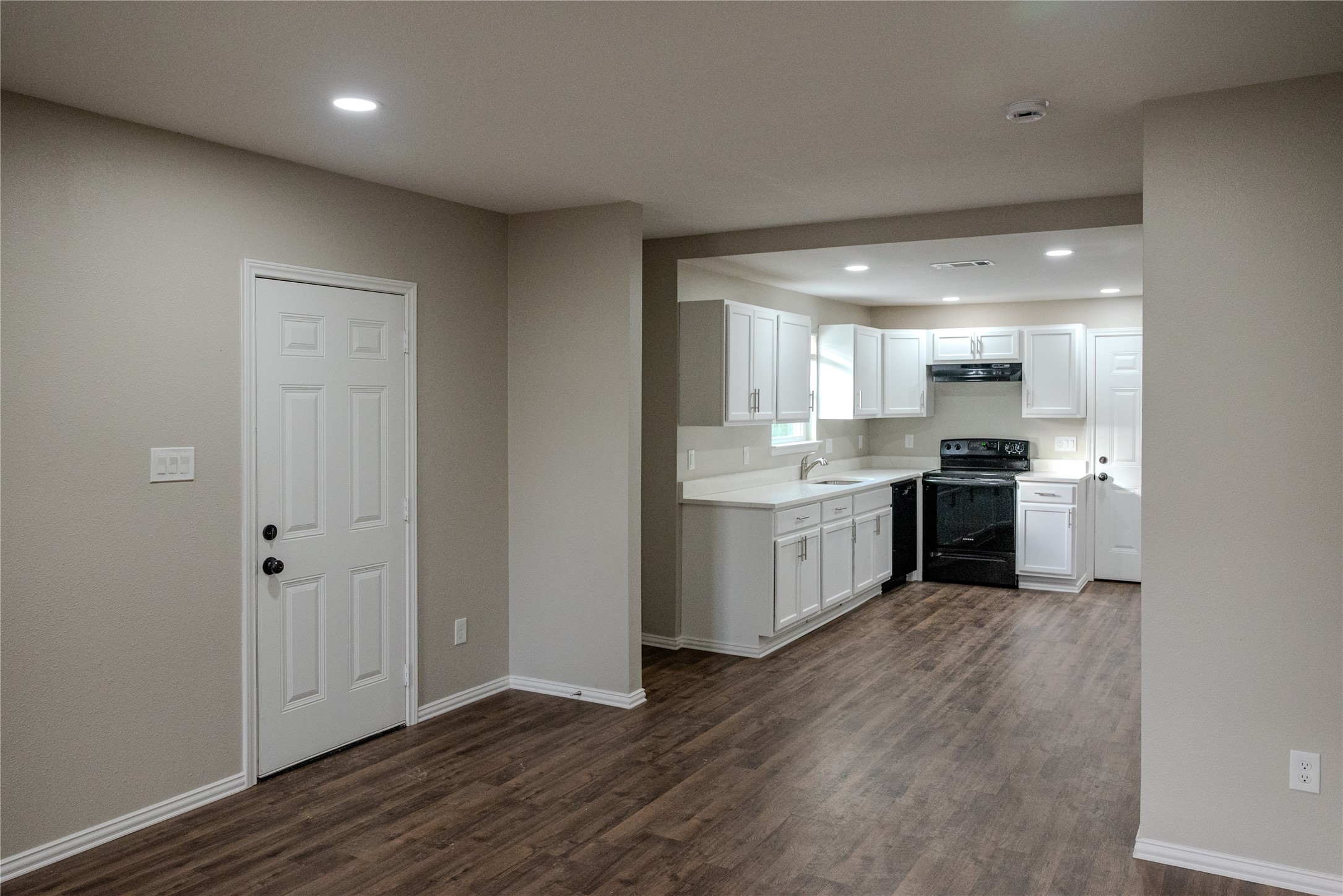 729 Planters Street Emory, TX 75440 - Photo 4 of 22 a kitchen with a white cabinets and wooden floor