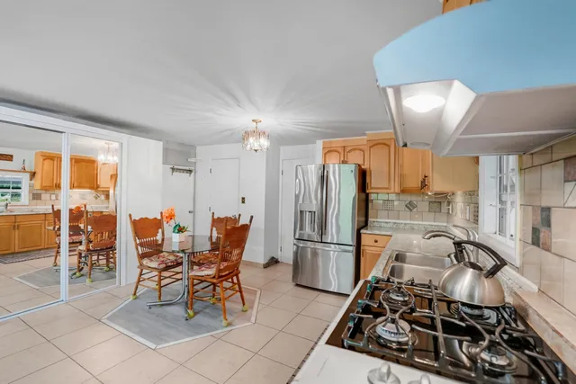 a kitchen with stainless steel appliances granite countertop a refrigerator and a stove top oven