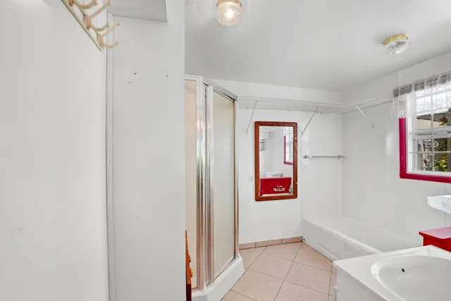 a bathroom with a bathtub and a shower