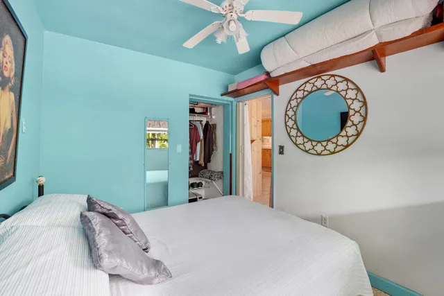 a bedroom with a bed and a chandelier