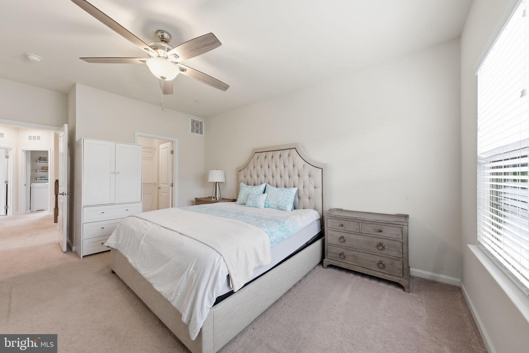 3012 Bretons Ridge Way Hanover, MD 21076 - Photo 18 of 37 a bedroom with a bed and a chandelier