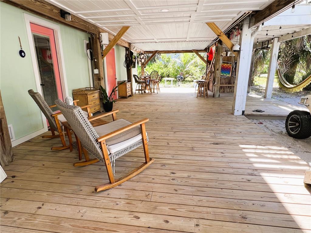 8662 Grand Avenue Boca Grande, FL 33921 - Photo 19 of 63 a view of a patio with wooden floor and iron stairs