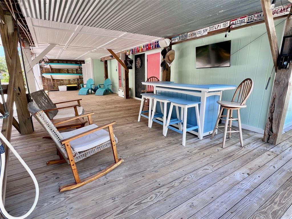 8662 Grand Avenue Boca Grande, FL 33921 - Photo 21 of 68 a outdoor space with lots of chairs and wooden floor