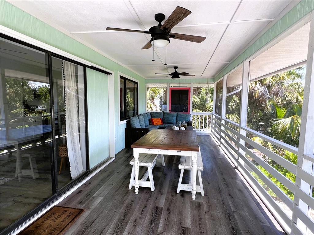 8662 Grand Avenue Boca Grande, FL 33921 - Photo 23 of 63 a view of a dining room with furniture window and wooden floor