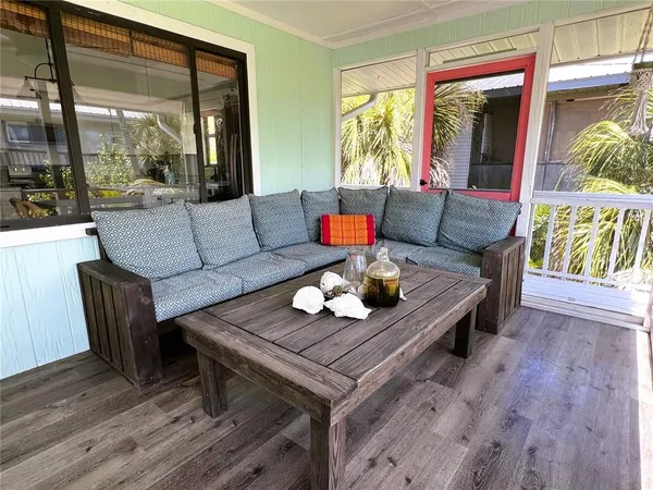 a living room with furniture a large window and a flat screen tv