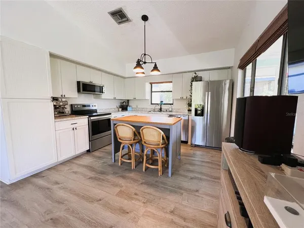 a bathroom with a granite countertop sink a toilet and shower