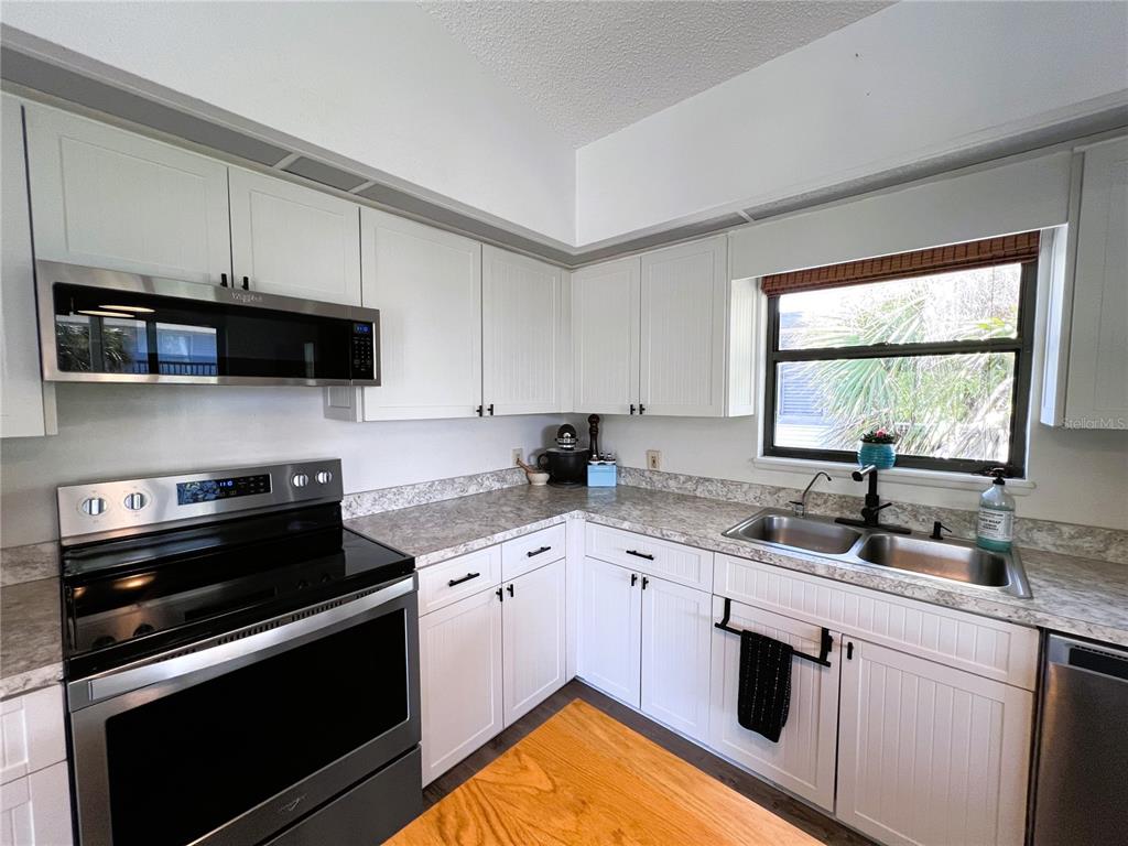8662 Grand Avenue Boca Grande, FL 33921 - Photo 35 of 68 a kitchen with a sink stove and microwave