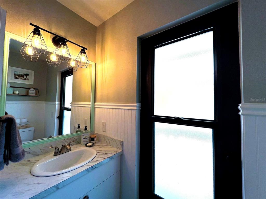 8662 Grand Avenue Boca Grande, FL 33921 - Photo 38 of 63 a bathroom with a sink and a mirror