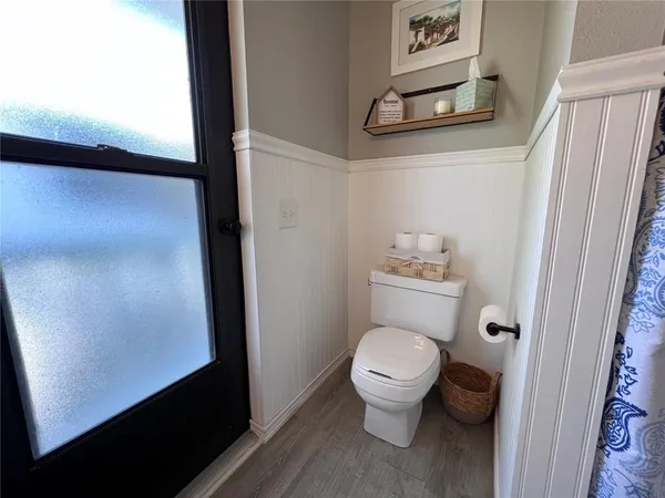 a bathroom with a toilet and a shower