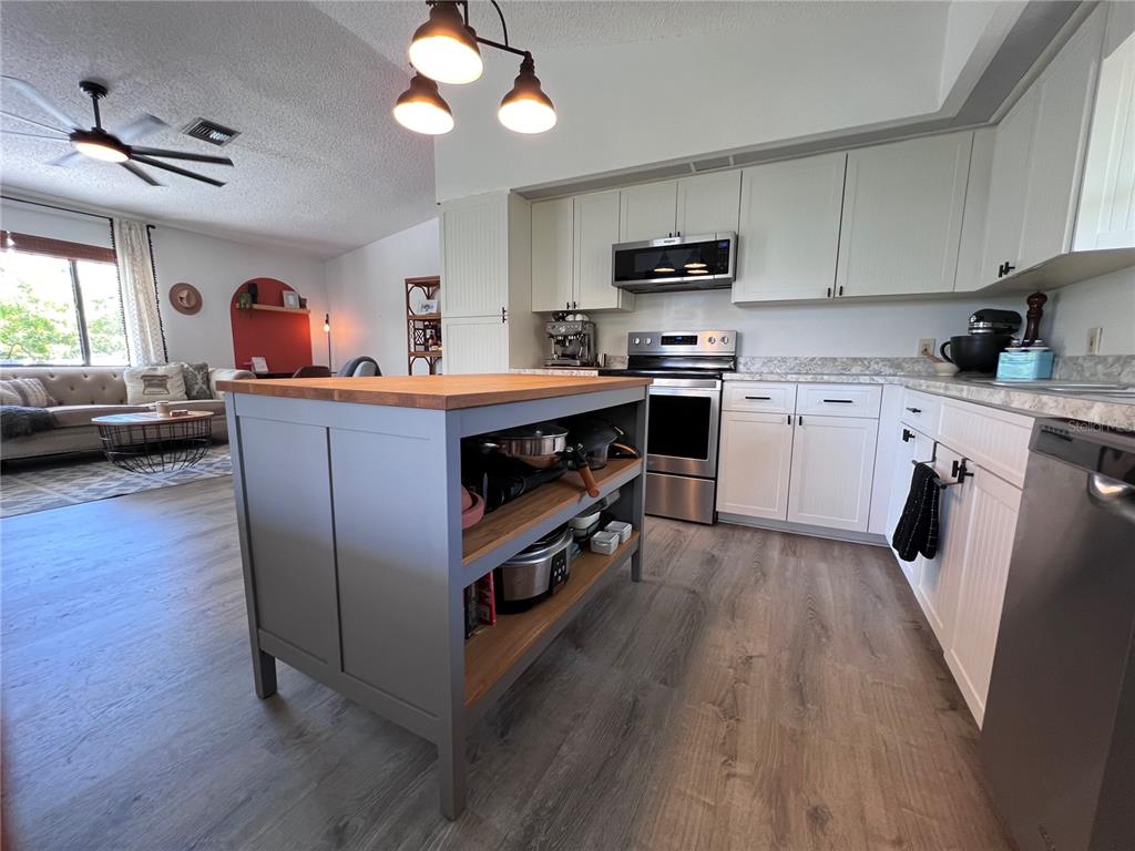 8662 Grand Avenue Boca Grande, FL 33921 - Photo 39 of 68 a kitchen with wooden floors and appliances