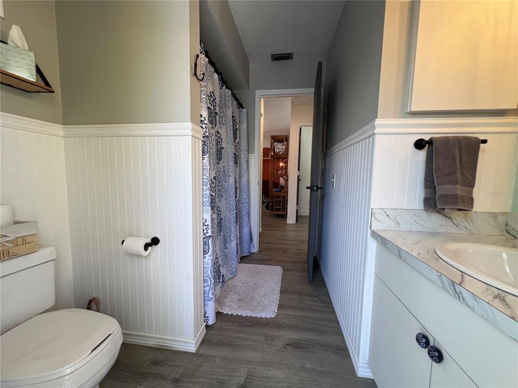 8662 Grand Avenue Boca Grande, FL 33921 - Photo 40 of 63 a bathroom with a granite countertop sink a toilet and shower