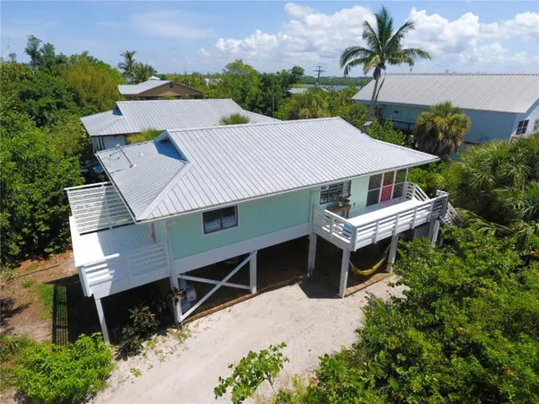 an aerial view of a house with balcony and outdoor space