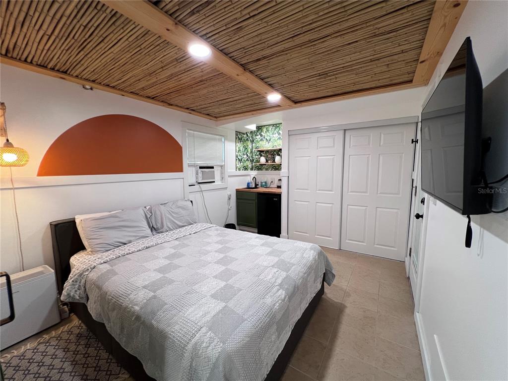 8662 Grand Avenue Boca Grande, FL 33921 - Photo 58 of 68 a spacious bedroom with a bed and a flat screen tv
