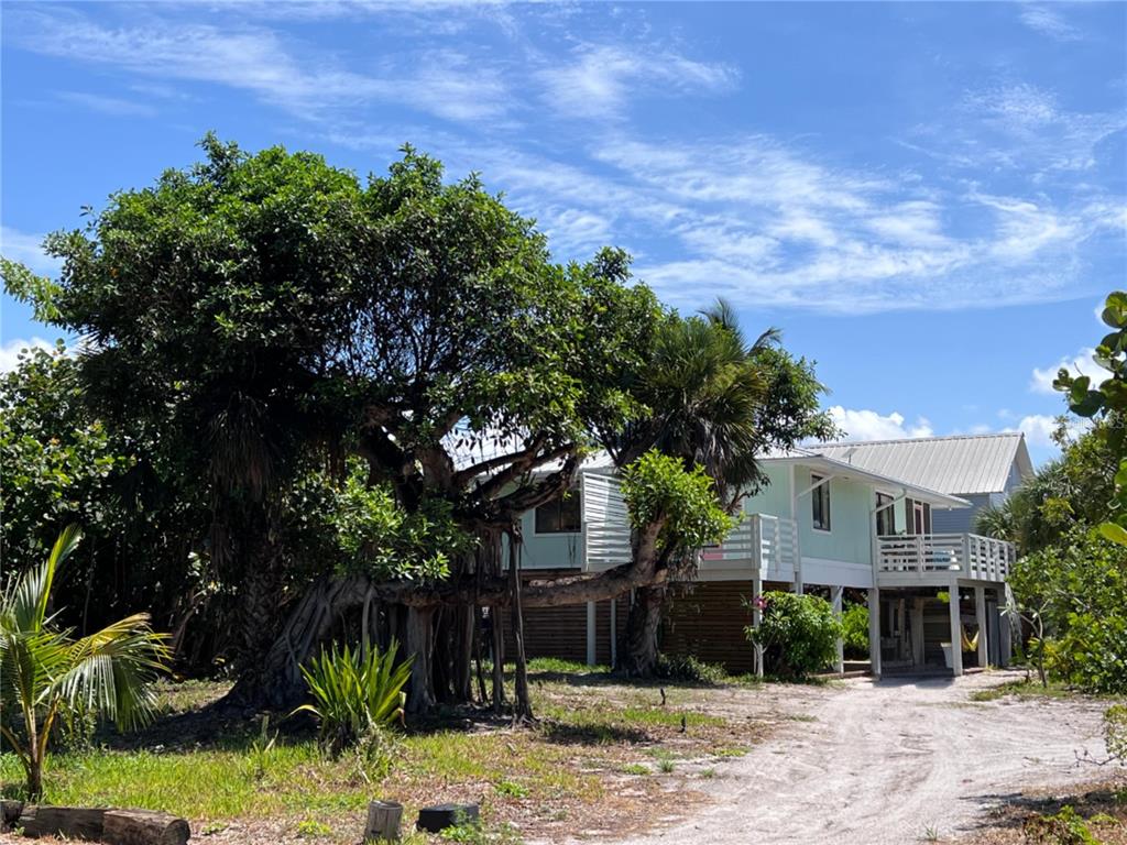 8662 Grand Avenue Boca Grande, FL 33921 - Photo 61 of 68 a front view of a house with a yard