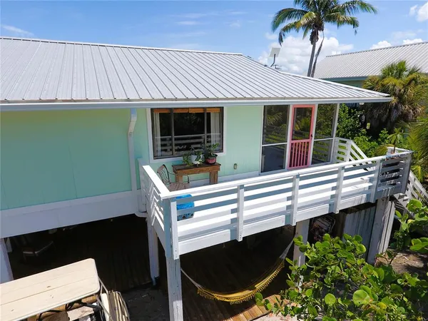 a view of a backyard with plants and chairs