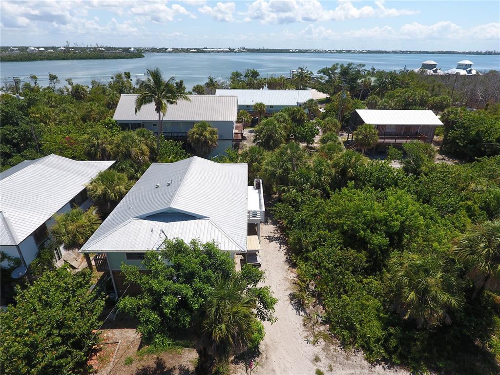 8662 Grand Avenue Boca Grande, FL 33921 - Photo 9 of 63 an aerial view of a house with river lake view and mountain view