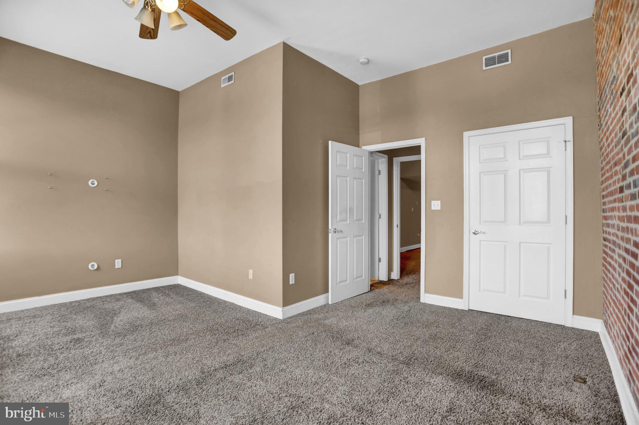 1103 Light Street, Unit A Baltimore, MD 21230 - Photo 12 of 23 a view of an empty room with a ceiling fan