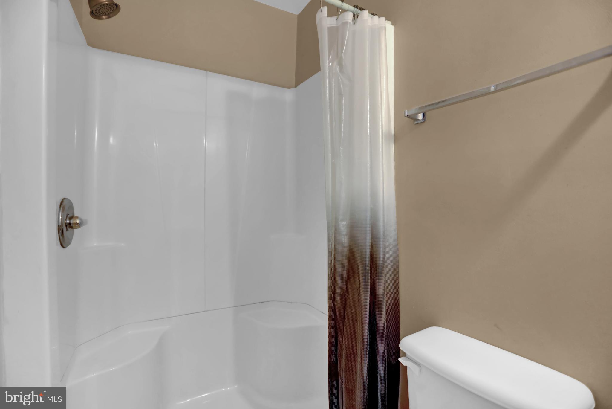 1103 Light Street, Unit A Baltimore, MD 21230 - Photo 16 of 23 a bathroom with a shower and a toilet