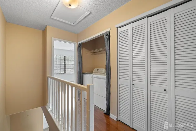 a view of a hallway with wooden floor and entryway