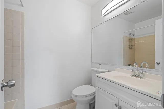 a bathroom with a sink toilet and a mirror