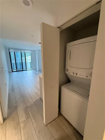 a view of a hallway with washer and dryer